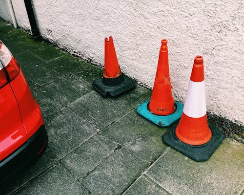 Traffic cones placed near car on road in city street