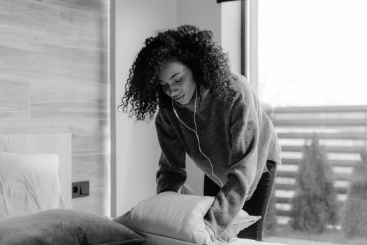 Grayscale Photo of Woman in Long Sleeve Shirt Sitting on Couch