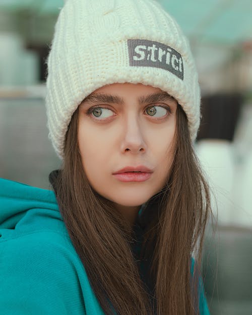 Close-Up Shot of a Pretty Woman in Teal Hoodie and with a Knitted Cap