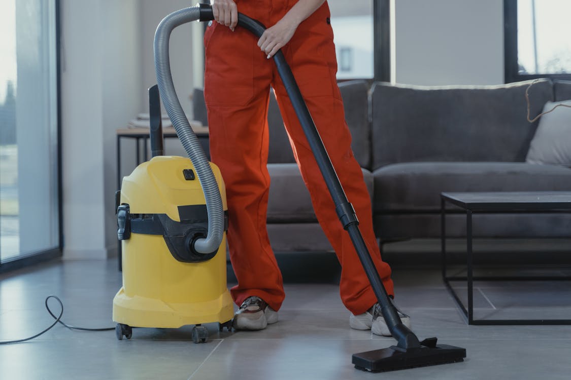 Free Person Using a Vacuum  Stock Photo