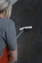 A Woman Cleaning a Wall
