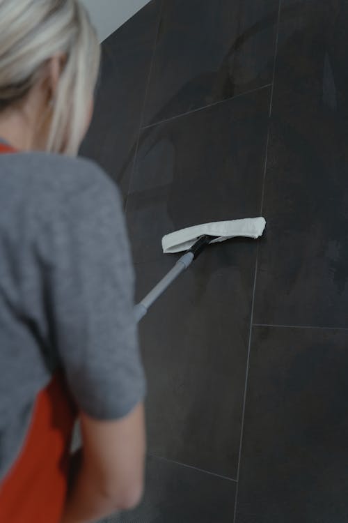 A Woman Cleaning a Wall