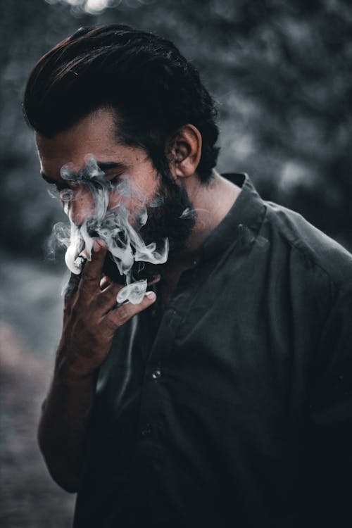 Free A Man Smoking a Cigarette Stock Photo