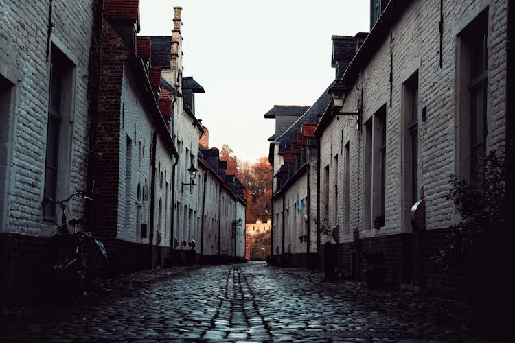 Narrow Cobblestone Street Between Rows Of Houses