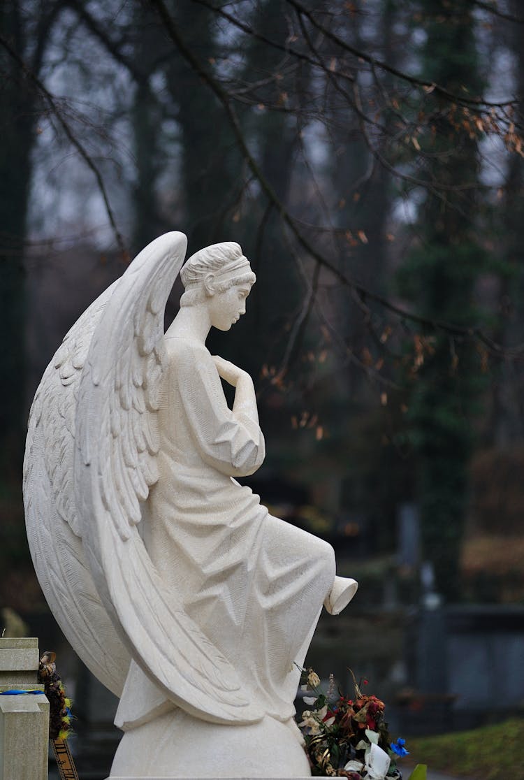 Side View Of An Angel Statue In A Cemetery