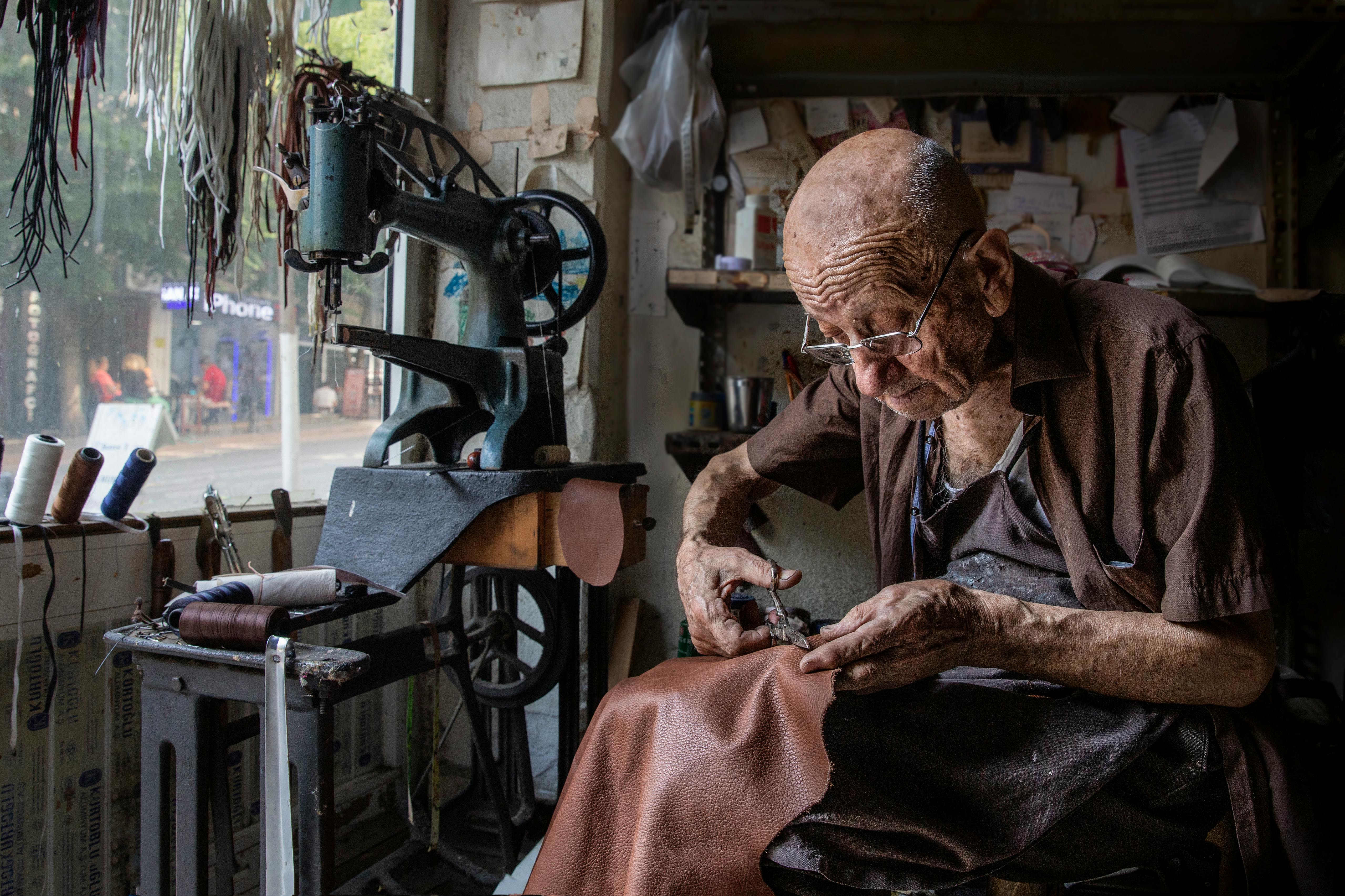 a man cutting leather