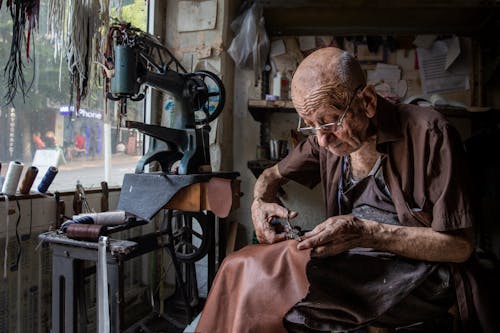 
A Man Cutting Leather