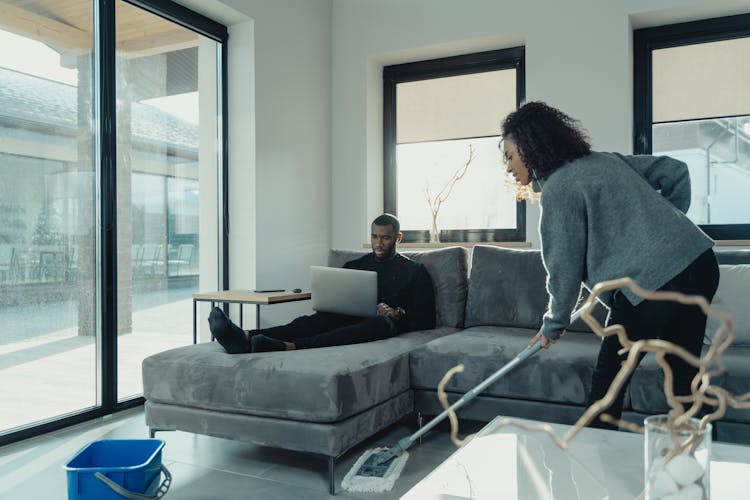 A Woman Cleaning The Living Room