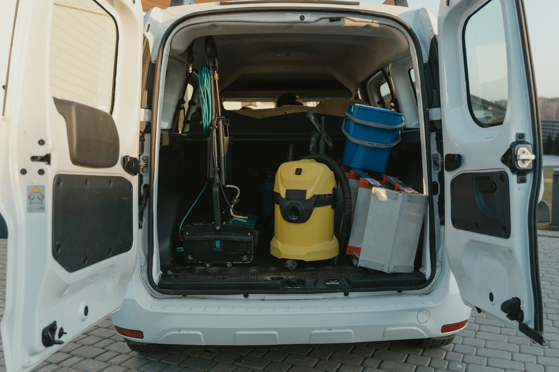 An image of cleaning equipment in the back of a van