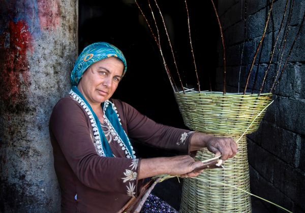 A weaver working a wicker basket by hand — photo by Canan YAŞAR on Pexels