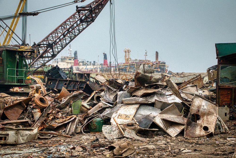 Large pile of scrap metal and industrial waste at a junkyard