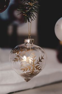 Clear glass drop ornament with a gilded snowflake, studio view — photo Mickael Martino on Pexels