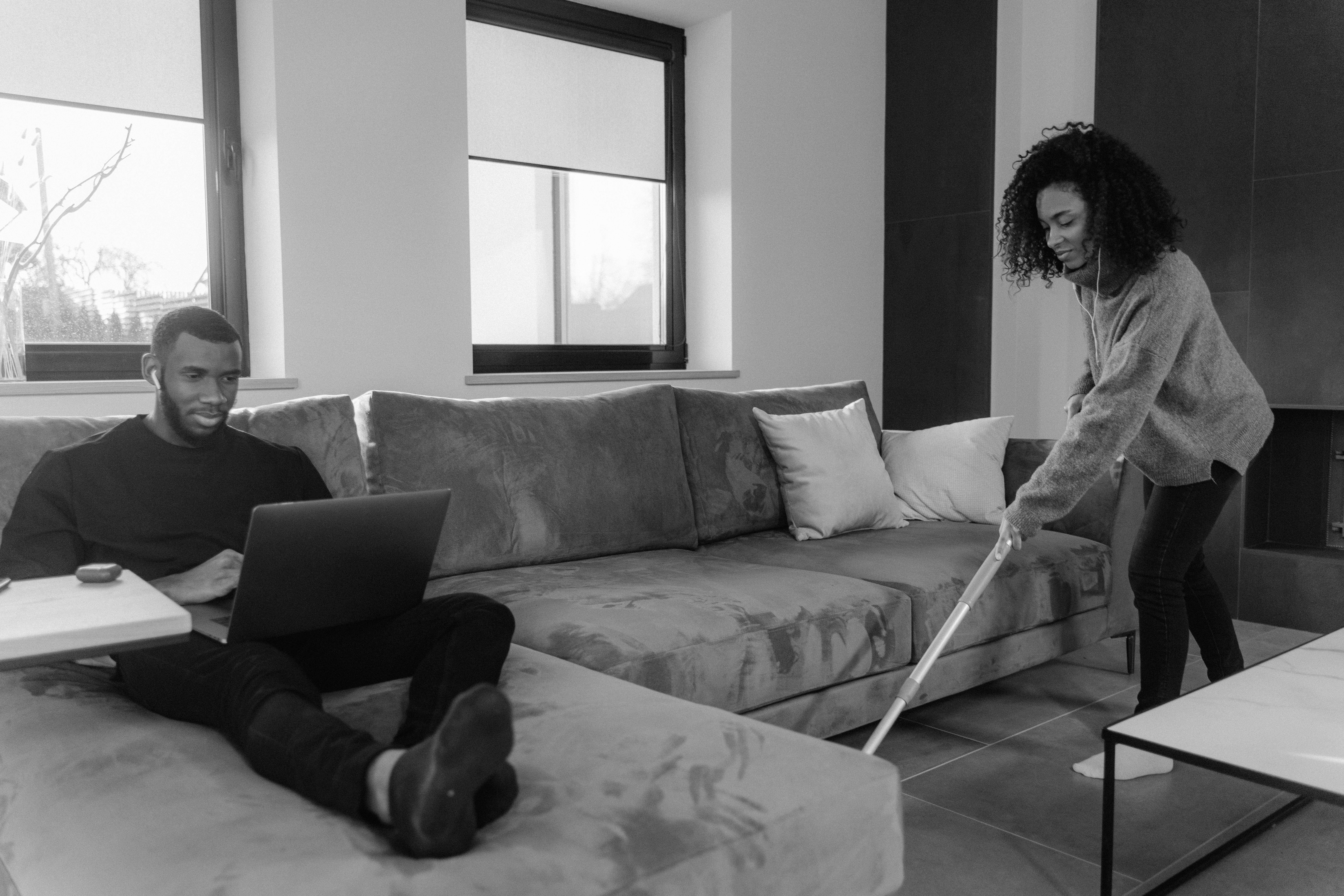 woman sitting on bed using laptop