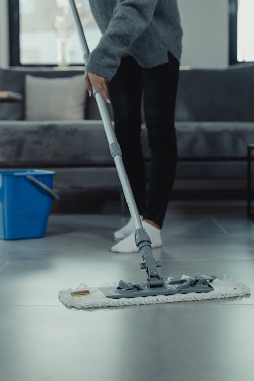 Person in Gray Sweater Mopping and Cleaning the Floor