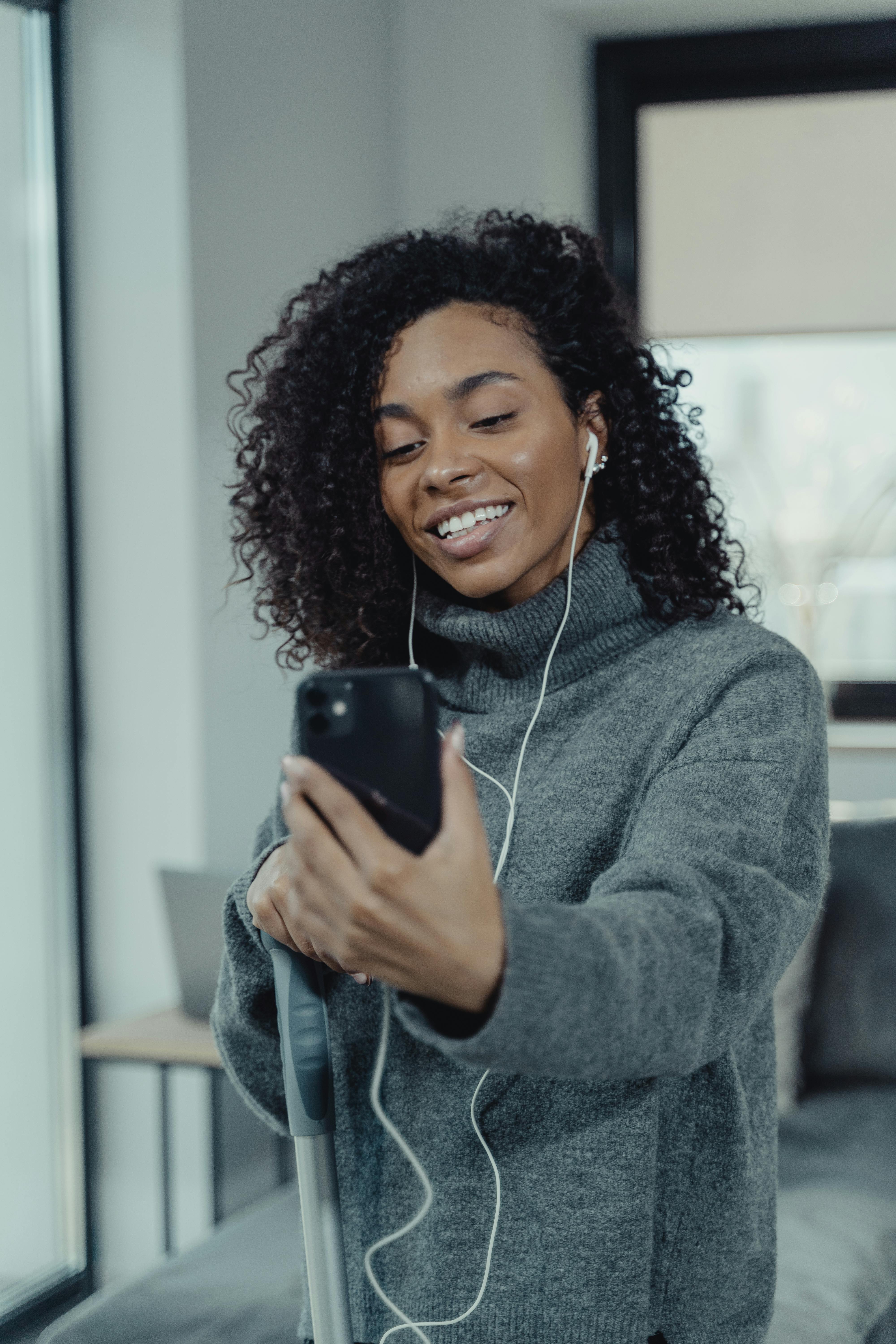 woman wearing earphones while on a video call