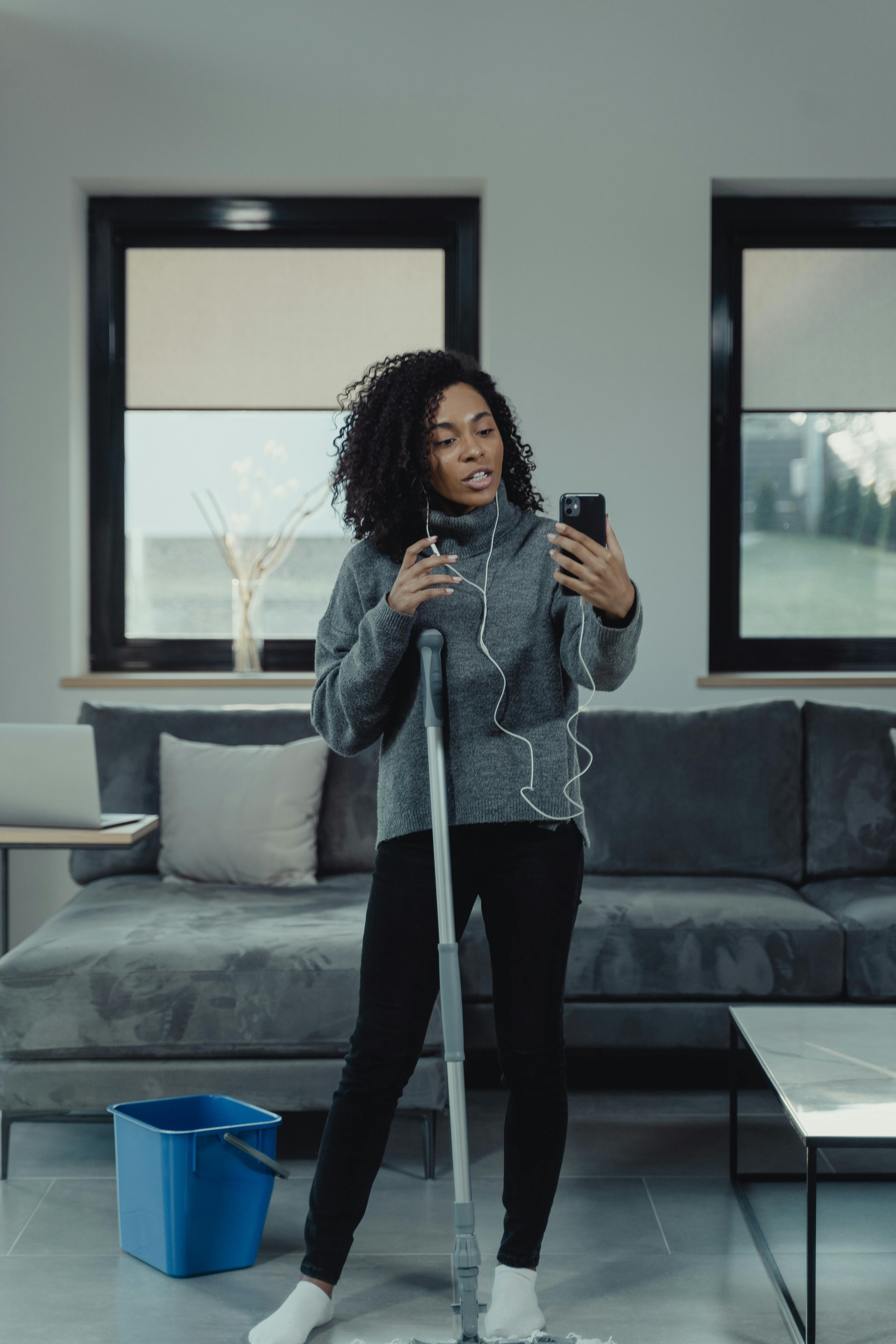 woman in gray sweater talking on a video call