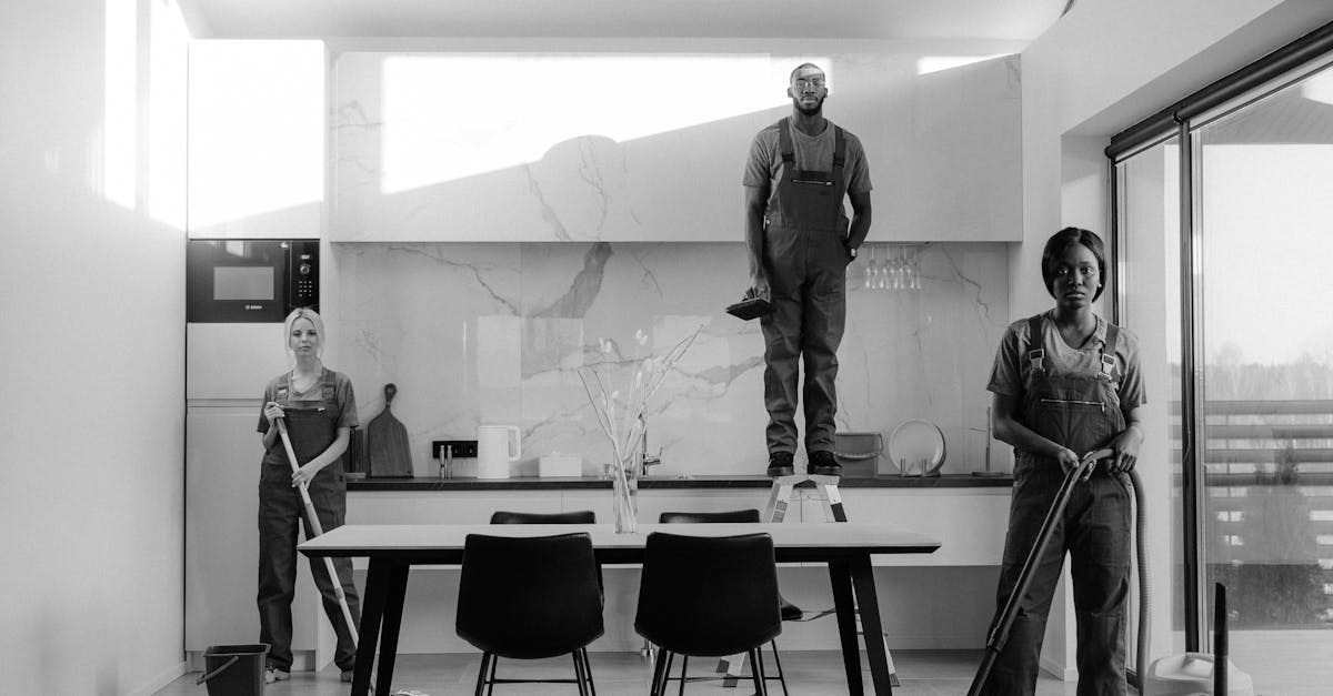 Grayscale Photo of People Standing Near Table