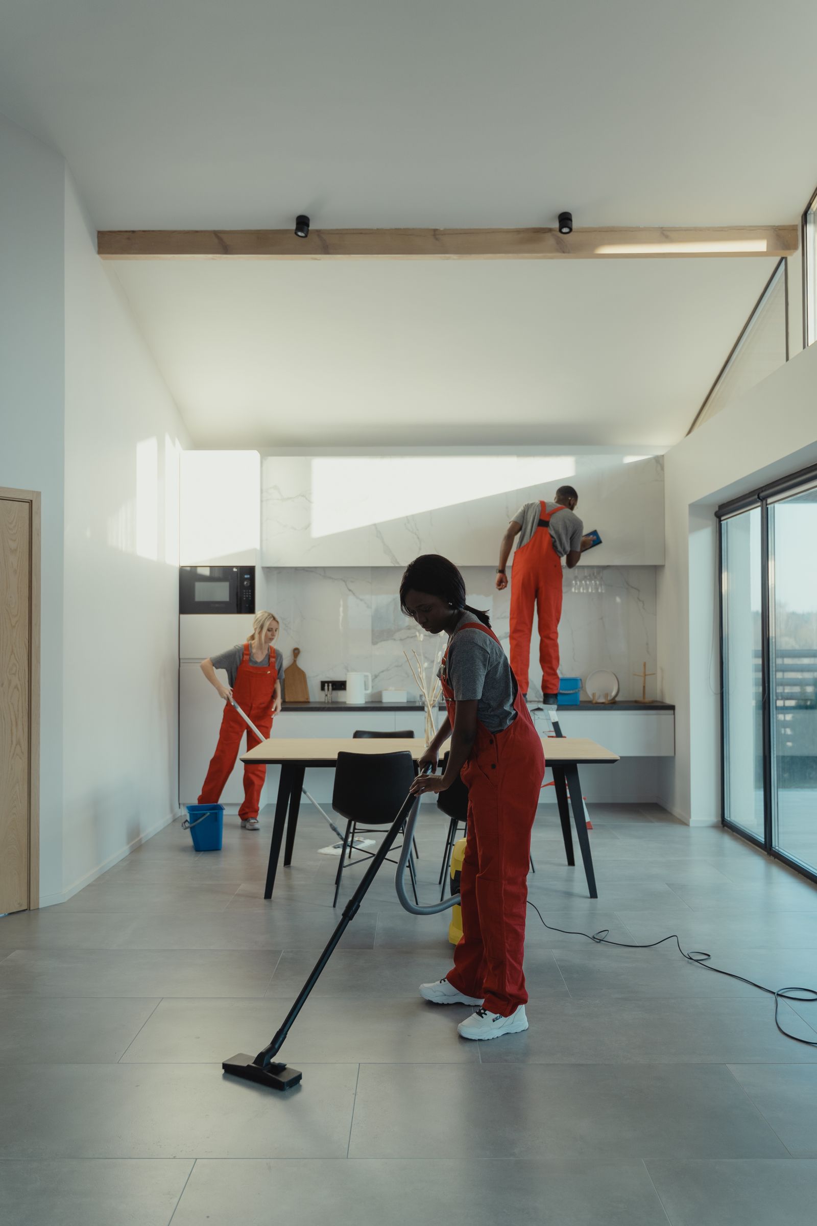 Professional cleaners working in a bright modern interior