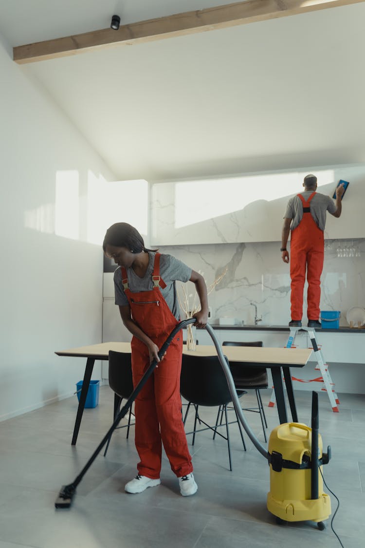 People Cleaning The Room