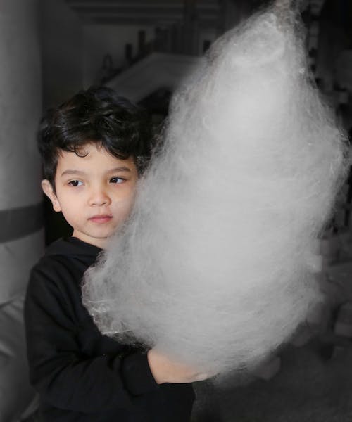 Photo of a Kid Holding Cotton Candy