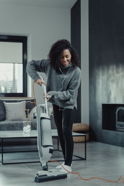 A person vacuuming a living room — photo by Tima Miroshnichenko on Pexels