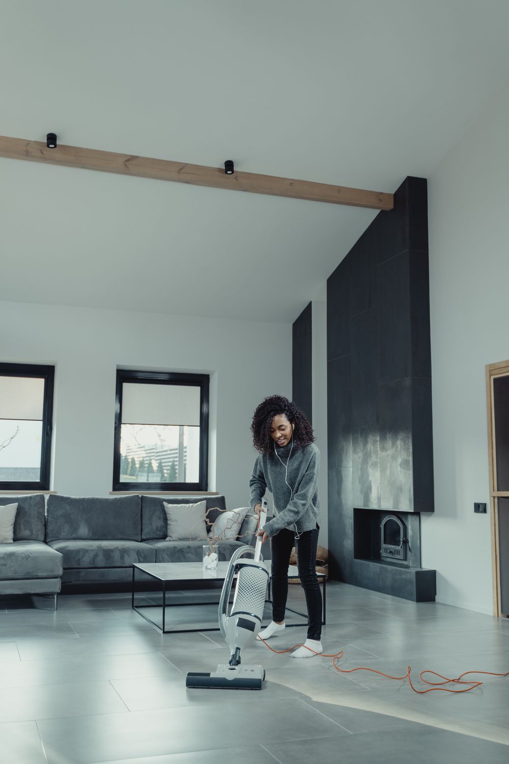 Vacuuming the floor of a bright living room