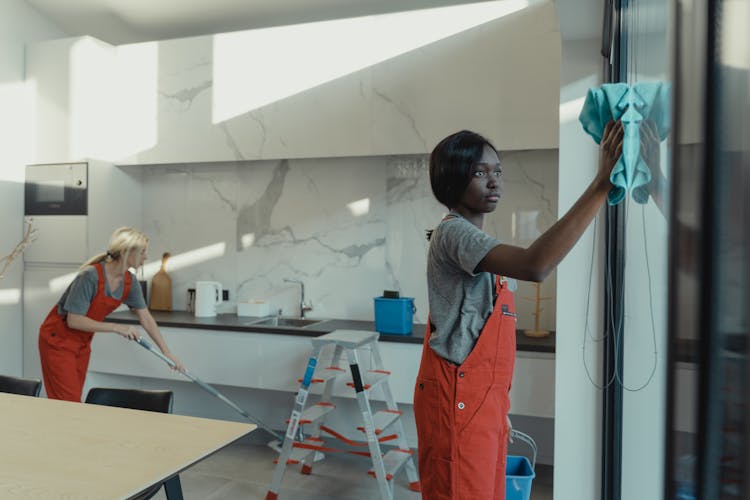 Women In Gray Shirt And Orange Jumper Cleaning The House