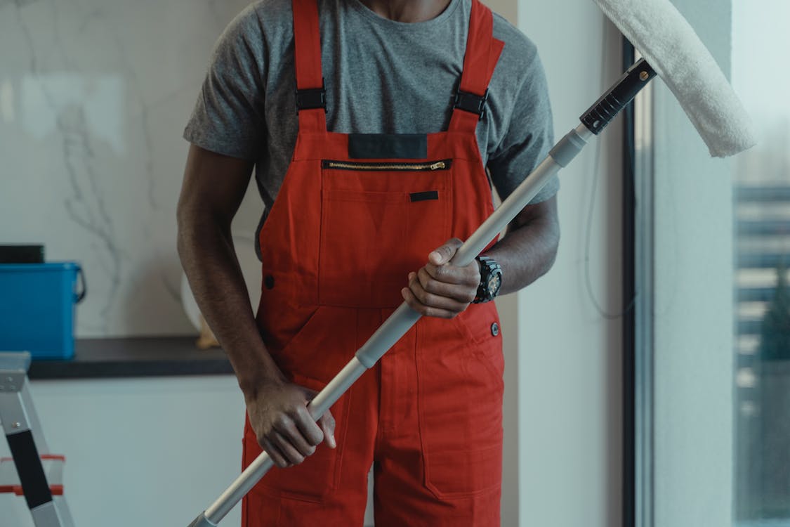In-Home Cleaning Services Orange Coveralls Stock Photo