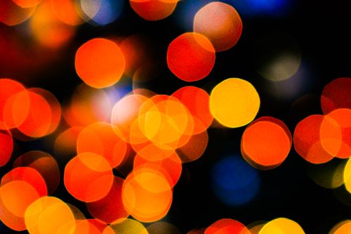 Free Vibrant bokeh lights creating a colorful and abstract pattern on a dark background. Stock Photo