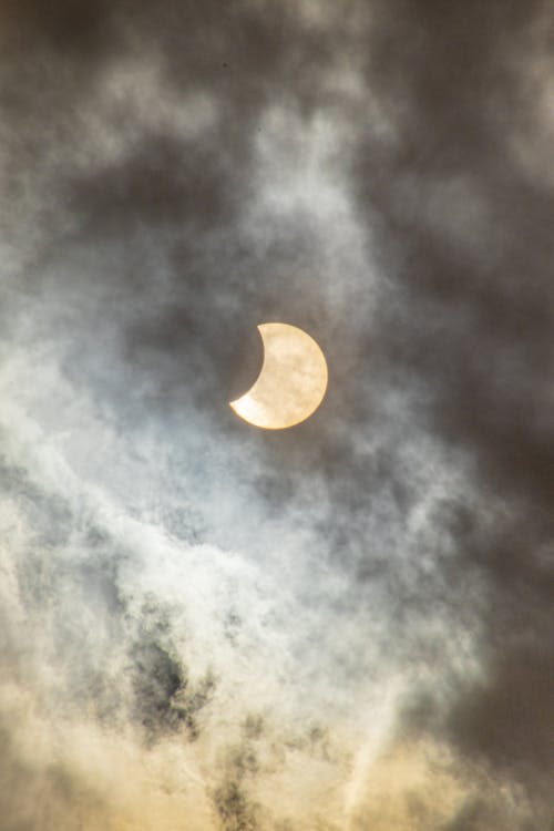 Solar Eclipse in the Cloudy Sky 