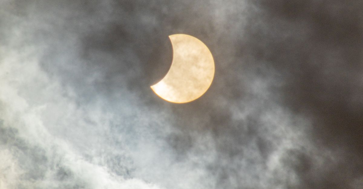 Solar Eclipse In The Cloudy Sky Free Stock Photo solar-eclipse-in-the-cloudy-sky-free-stock-photo