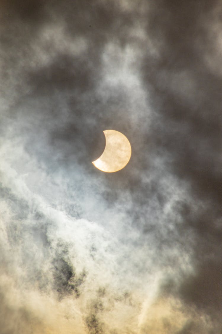 Solar Eclipse In The Cloudy Sky 