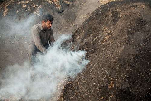 Man Burning Charcoal Under the Ground