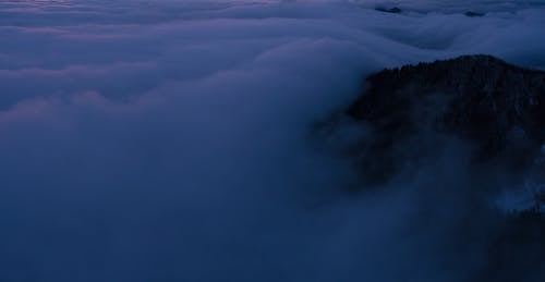 Free Clouds Covering a Mountain Stock Photo