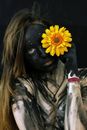 Woman in Black Leather Jacket With Yellow Sunflower on Her Face