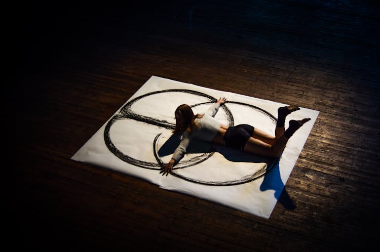 Female Artist Painting With Bare Hands In A Dark Studio