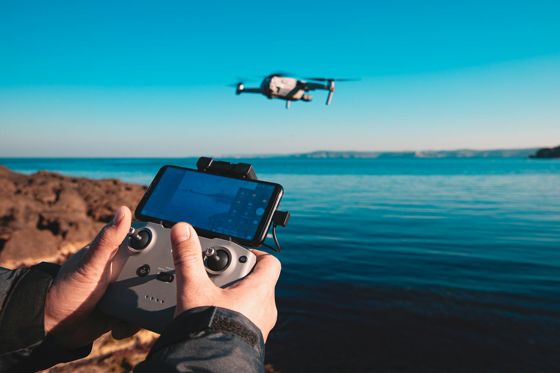 A drone is operated over scenic blue waters near Istanbul, showcasing technology and sea views.