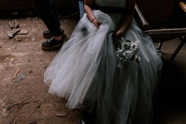 Bride in a white gown holding a bouquet of white flowers