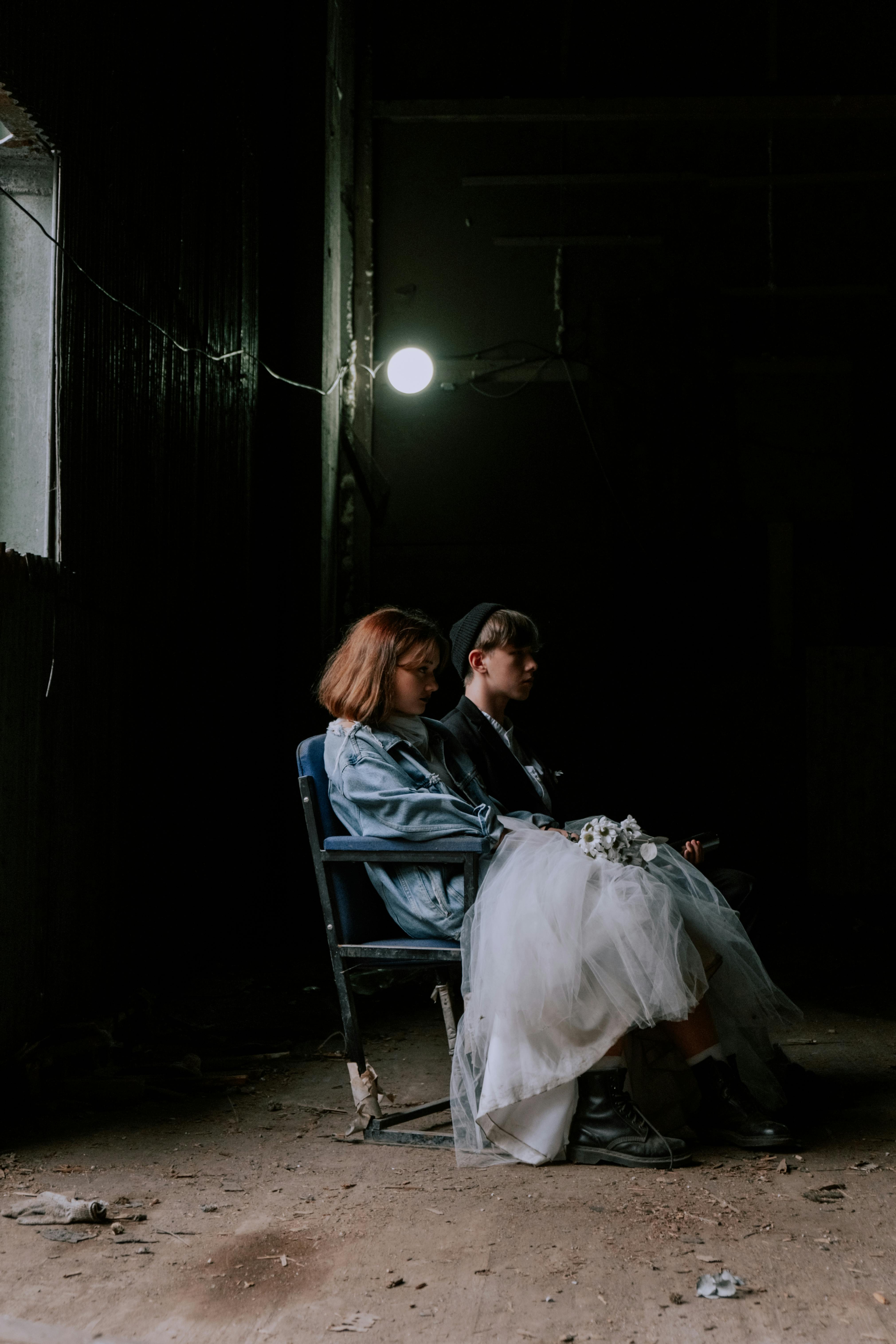 woman in white dress sitting on blue chair