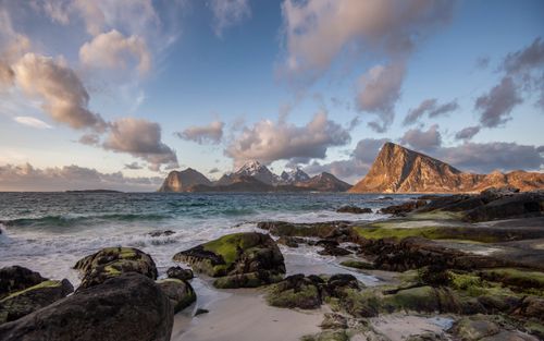 Free Serene view of the rugged coast in Nordland, Norway, with mountains and clouds at sunset. Stock Photo
