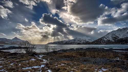 Free Body of Water Beside Mountains Stock Photo