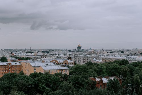 Free A panoramic view capturing a city's skyline with lush greenery and overcast skies. Stock Photo