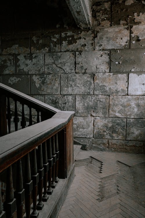 Damaged Floor and Brick Walls of an Abandoned Building