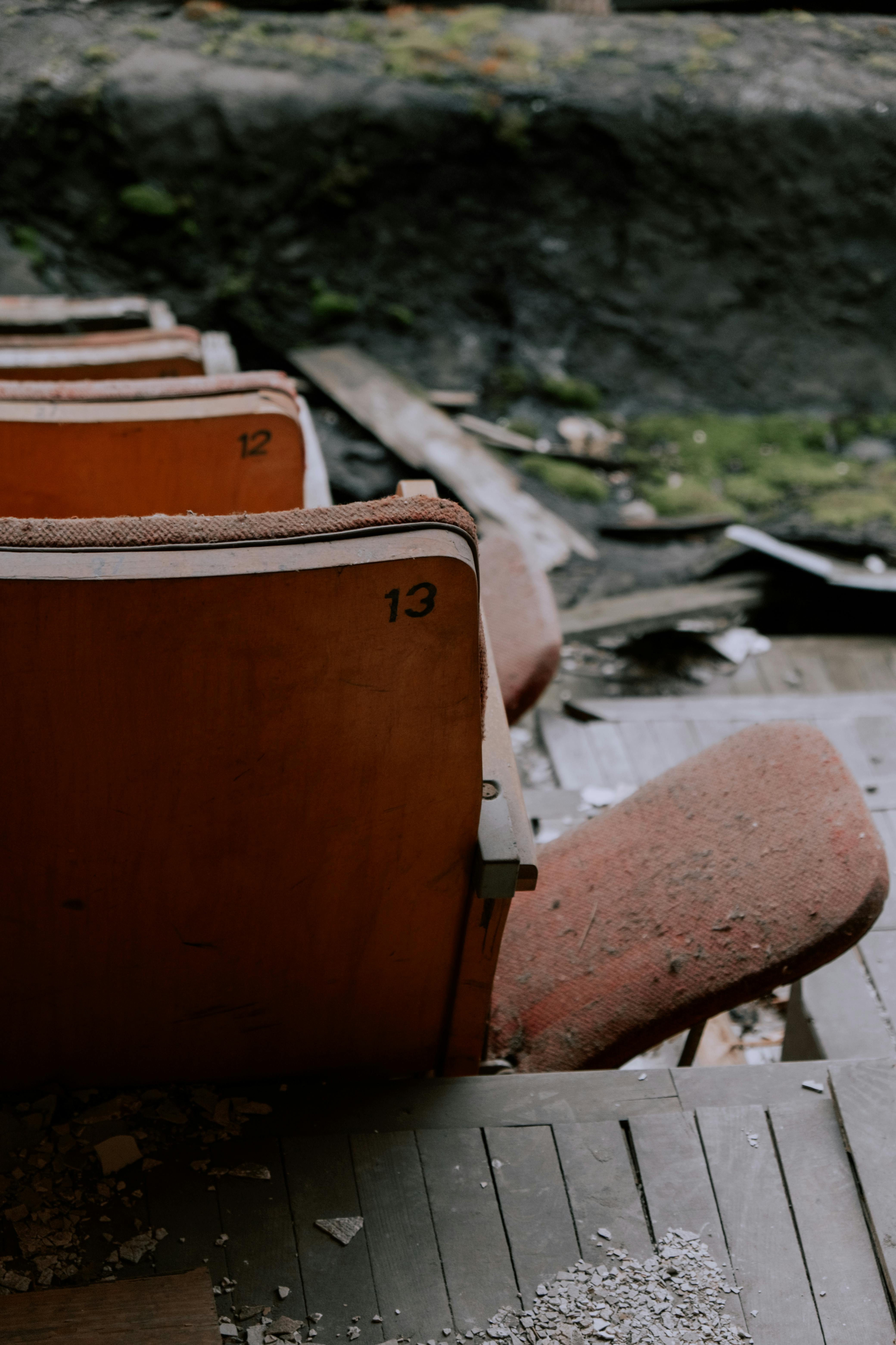 Free Weathered theater seats in an abandoned location, illustrating decay and neglect. Stock Photo