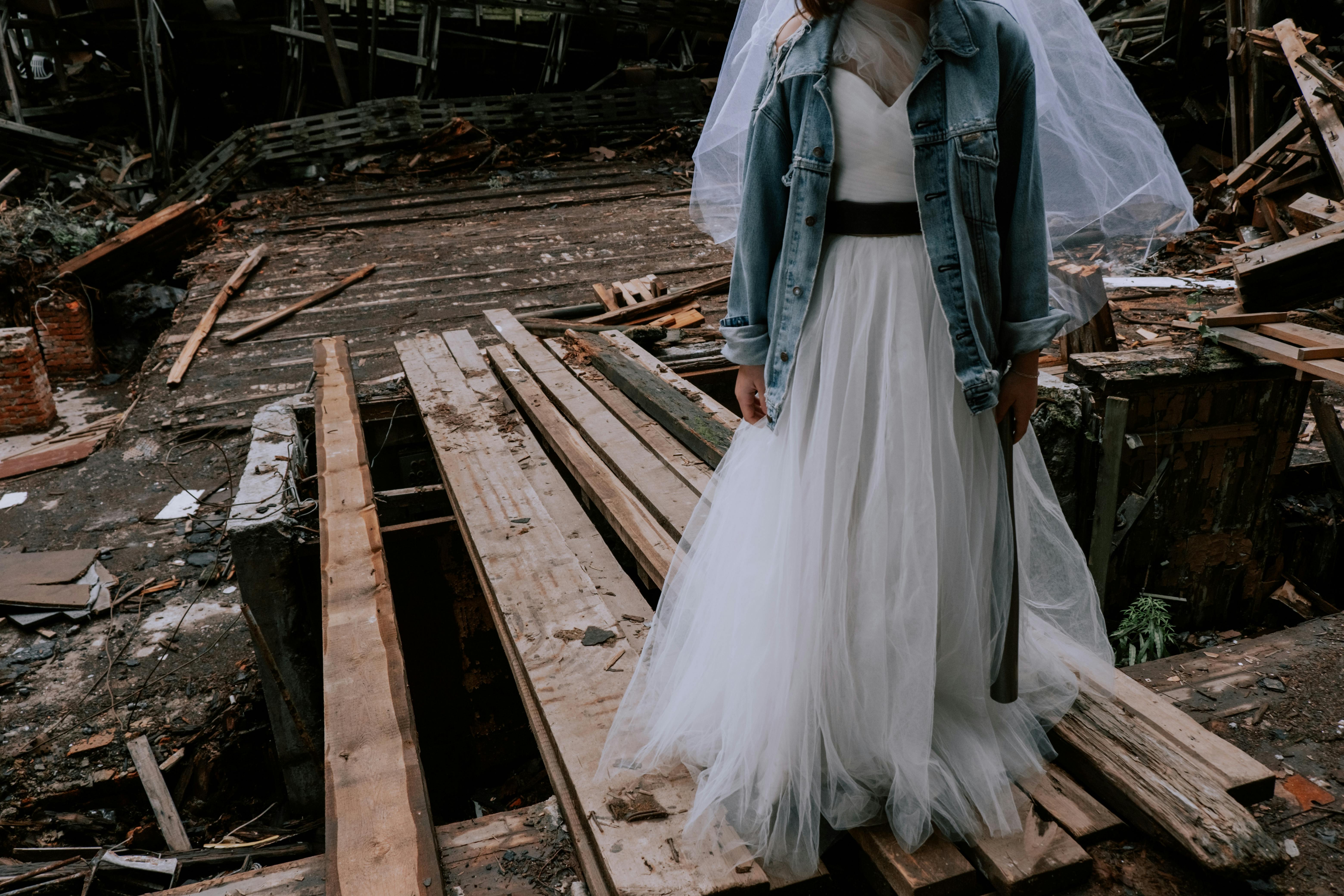 Woman in White Wedding Gown Standing on Wooden Planks  Free Stock Photo