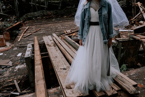 Free Woman in White Wedding Gown Standing on Wooden Planks Stock Photo