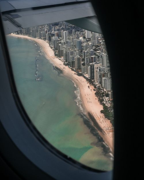 Free Stunning aerial view of Recife's skyline and coastline through airplane window. Stock Photo