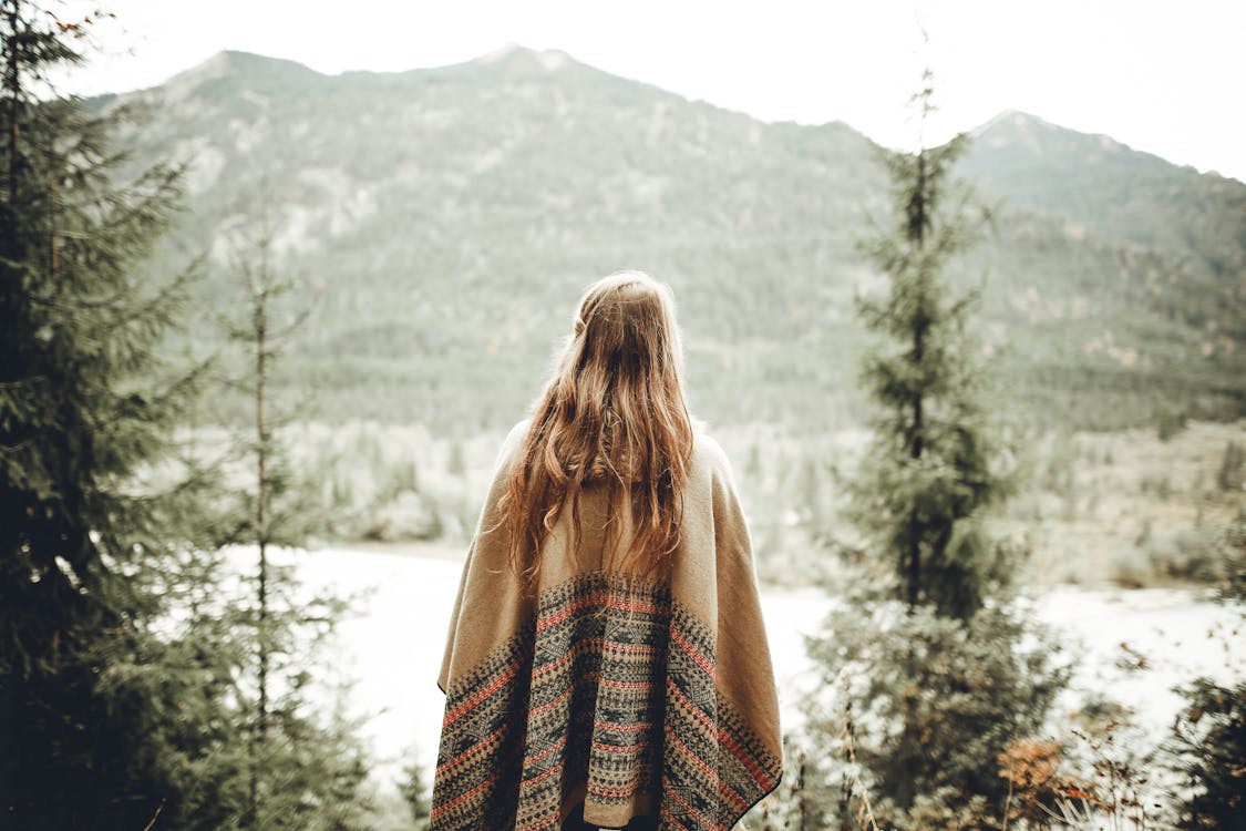 Free Woman Wearing Brown Poncho Facing Mountain Stock Photo