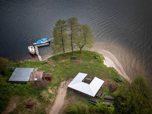 Free Aerial shot of a lakeside area with boats and picnic benches in Wdzydze Kiszewskie, Poland. Stock Photo