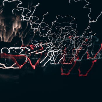 Abstract urban scene with long exposure light trails on a nighttime city street.